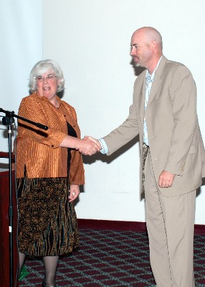 Gary Ahrens, vice president for programs, thanks guest speaker Lynn B. Moad, chief, systems integration division, Directorate of Logistics and Sustainment, Headquarters Air Force Materiel Command/A-4, Wright-Patterson Air Force Base, Ohio, at the September meeting.
